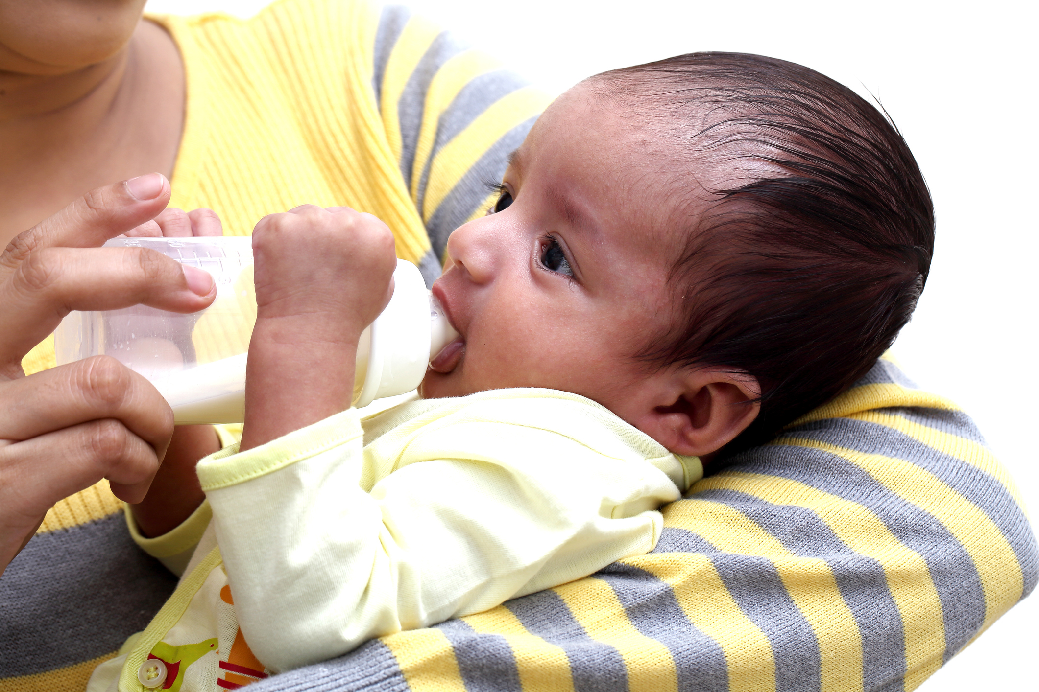 Newborn baby is drinking formula